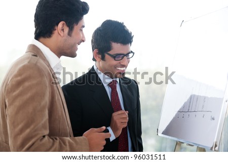 two happy businessmen discussing business strategy in a meeting, Indian business man with latin american colleague