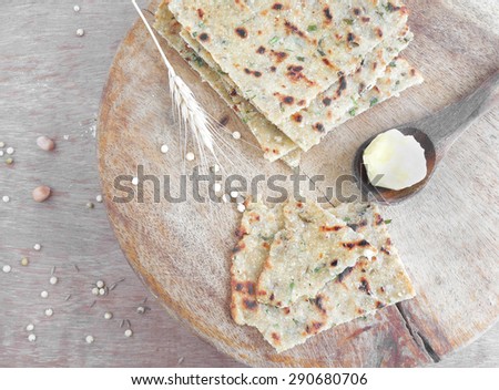 Flat bread pieces, made from multiple grains, soft focus.