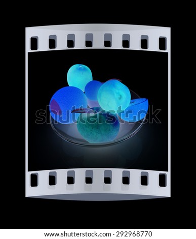 Citrus and apples on a black background. The film strip