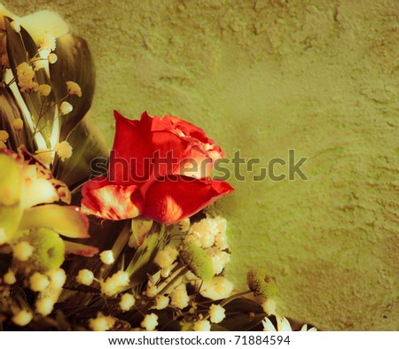 Bouquet with red rose on a background wall. Vintage styled.