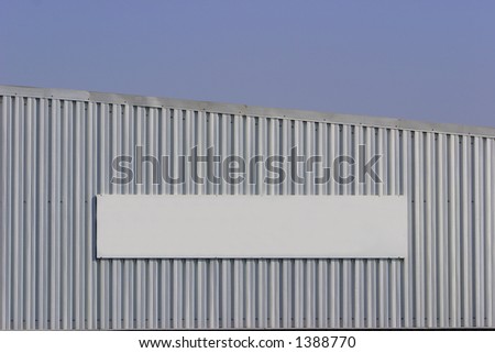 Blank sign on a factory wall.