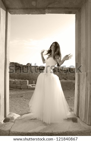 Beautiful bride in the white dress The greece ancient door. Black and white, sepia