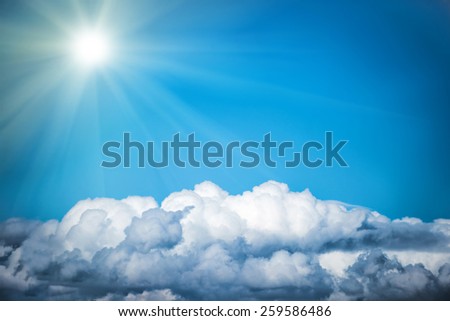 White clouds and bright sun on the blue sky. Nature background