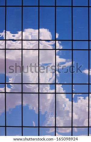 Reflections of clouds and sky on a shiny surface