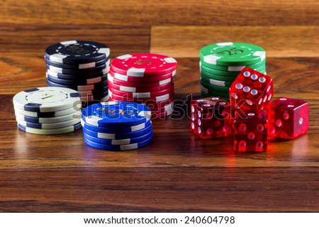 Chips and dice on a dusty wooden table