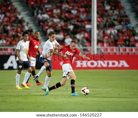 BANGKOK - JULY 13:Tom Cleverley (R) of Man Utd. in action during Singha 80th Anniversary Cup Manchester United vs Singha All Star at Rajamangala Stadium on July 13,2013 in Bangkok, Thailand.