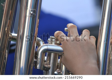 Fingers of a musician playing the  trumpet