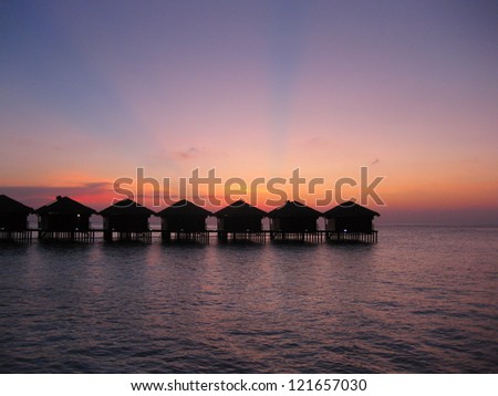 Silhouette of water villas in the paradise sunset at the Maldives.