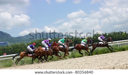 PYATIGORSK, RUSSIA - JULY 4: Jockeys (L - R) Hatkov, Hamidulin, Aituganov,Mardanov  and Guseinov race for the prize of the Oktava on July 4, 2011 in Pyatigorsk, Caucasus, Russia.  Image ID: 79956127