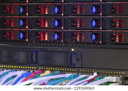 Network hub and server rack storage with connection cables and red lights