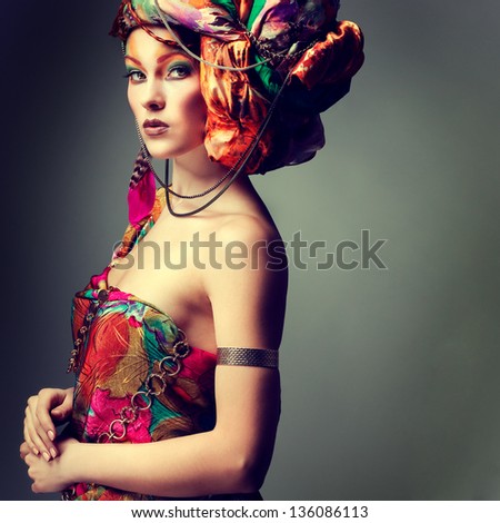 A photo of beautiful redheaded girl in a head-dress from the coloured fabric, glamour