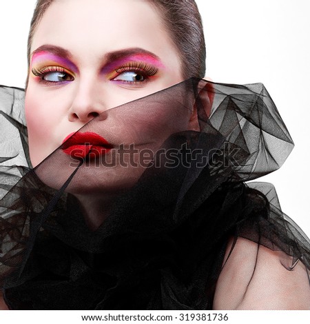 Portrait of sexual young girl in a black veil isolated on a white background