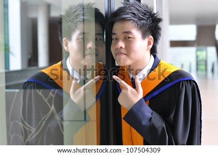Fashion of graduate in thailand ,graduation boy holding his master\'s degree.