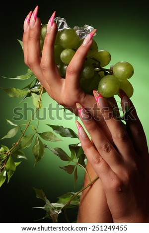 beautiful hands and nails on green background . Beautiful Female Hands.Manicure concept
