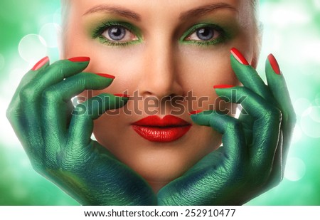 beautiful girl with green hands.  Perfect makeup. Perfect skin. Fashion photo