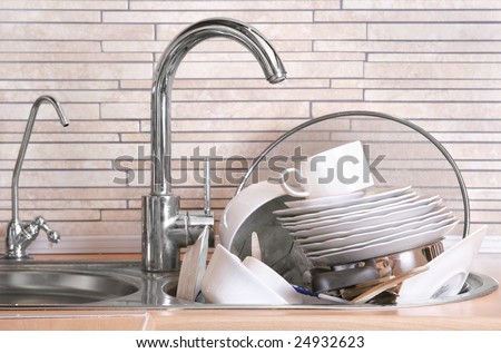 Pile of dirty dishes in the sink