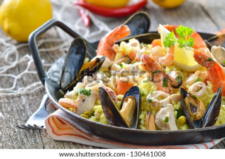 Tasty Spanish paella with seafood and chicken breast