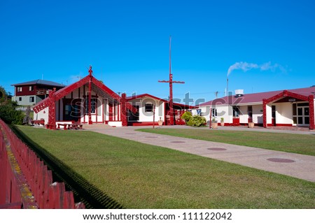 This image shows a Maori marae (meeting house and meeting ground)