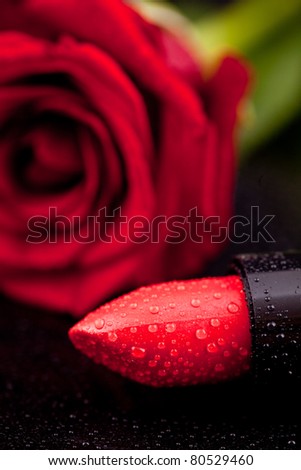 lipstick and nail polish on a background of roses, flowers, pearls and drops of water