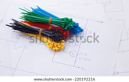 Plastic ties on a background of the electric scheme