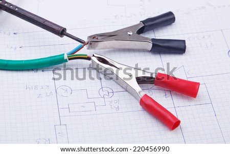Electric clamps and adhesive plastic tape  on a background of the electric scheme