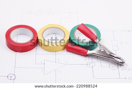 Electric clamps and plastic ties on a background of the electric scheme