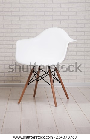 White chair on a brick wall background