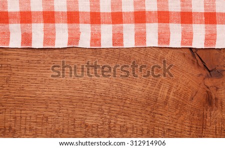 Tablecloth red and white checkered wavy on wooden table
