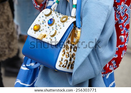 MILAN - FEBRUARY 25: Woman poses for photographers with backpack with gems before Gucci show Milan Fashion Week Day 1, Fall/Winter 2015/2016 street style day 1, on February 25, 2015 in Milan.