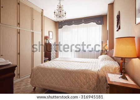 Old bedroom with queen size bed in cozy house