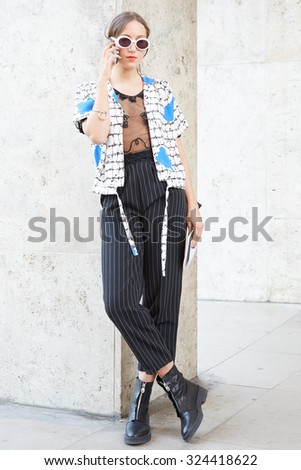 PARIS - SEPTEMBER 30: Woman poses for photographers before Rochas show, Paris Fashion Week Day 2, Spring / Summer 2016 street style on September 30, 2015 in Paris.