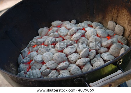 Hot glowing coals in a backyard barbecue grill