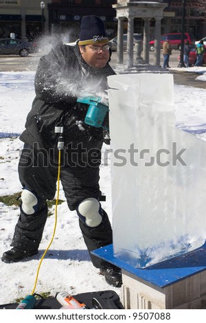 An artist sculpting a block of ice for a competition