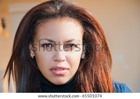 face of a young mulatto woman close-up, beautiful almond eyes