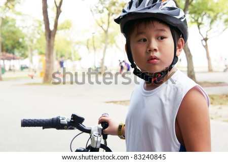 Cycling boy look back in surprise.