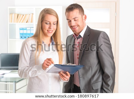 Business people reading a document together in the office