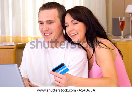 Happy couple paying by credit card