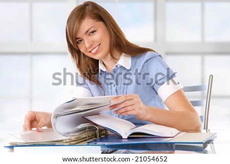 Woman in office or school or home working with papers