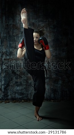 Kick boxing fighting woman wearing boxing gloves