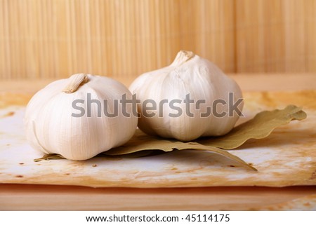 Two garlic heads with leaves