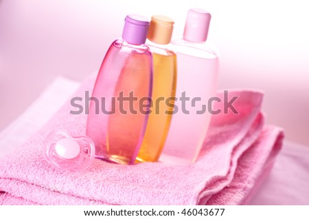 Baby care objects. Olive, shampoo, gel, towels and dummy
