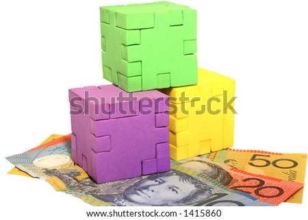 3 different coloured puzzle blocks stacked with Australian $10, $20, $50 note