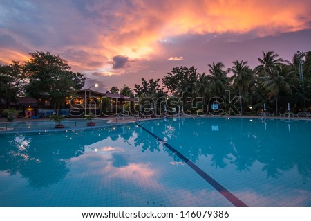 Swimming pool in luxury hotel after sunset.