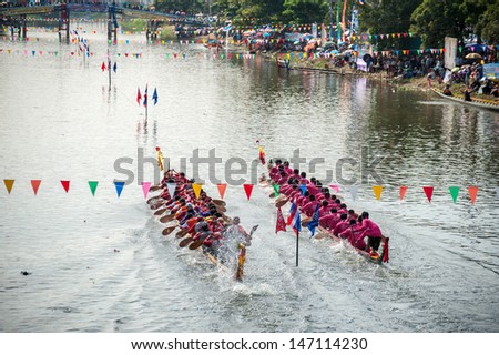 PATUMTHANI, THAILAND - OCT 28: Two rowing teams in full speed during Thai Long-tailed Boat Competition for Royal Championship Cup on October 28, 2012 in Rangsit, Pathumthani, Thailand.