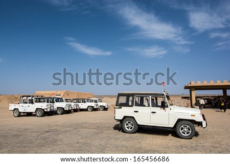DUNHUANG,CHINA-OCTOBER 17:The jeep waiting people at Yadan landforms on October 17,2013 in Dunhuang ,Gansu,China.Yadan Landforms is physiognomy landscape formed by Aeolian cover 400 square kilometers.