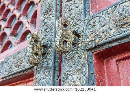 BEIJING,CHINA - MARCH 29 ,2011 : Golden key in the door of the Forbidden City in Beijing,China. It is located in the center of Beijing, China, and now houses the Palace Museum.