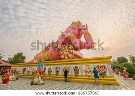 CHACHOENGSAO, THAILAND - MARCH 17, 2014 :People at Ganesha statue the Hindu god that whose head is an elephant head at Wat Saman Rattanaram. He is a god of knowledge and success.