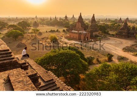 Bagan,Myanmar-March 19,2011 : Unidentify Myanmar man looking  plain of temples of Bagan on sunrise in Bagan,Myanmar.