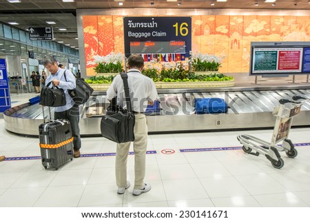 Bangkok,Thailand-October 01,2014 :  Passengers looking the baggages at baggage claim area at international arrival  terminal in Suvarnabhumi Airport in Bangkok,Thailand.