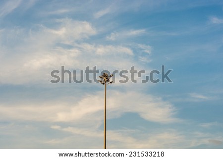 Spot light pole with blue sky.